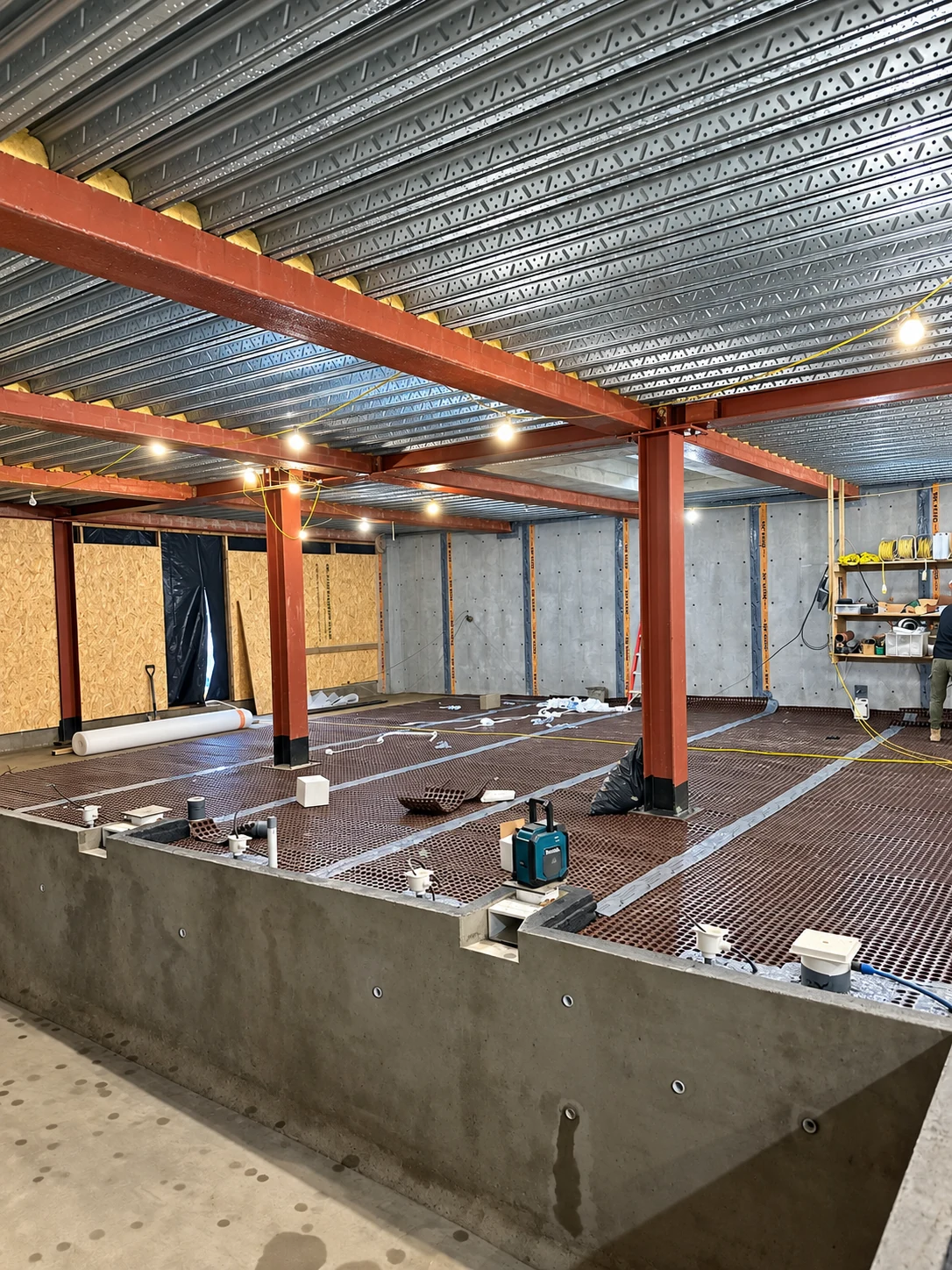 Wide view of swimming pool waterproofing within a larger basement project